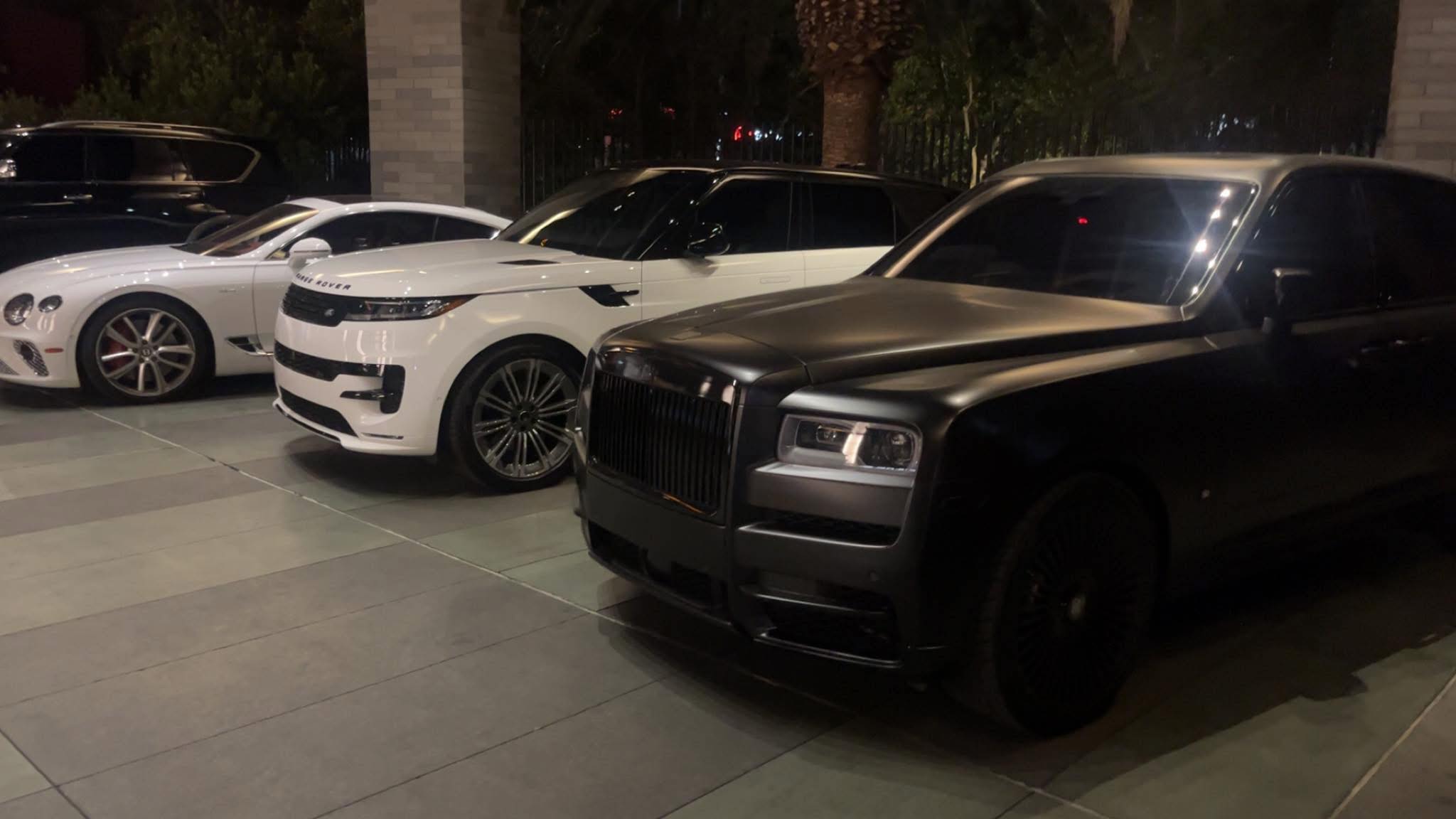 Luxury vehicles lined up after detailing at night